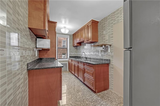 345 Webster Ave Unit 3N, Brooklyn, NY 11230 - kitchen featuring freestanding refrigerator, white microwave, dark stone counters, granite tiled floors, and tile walls