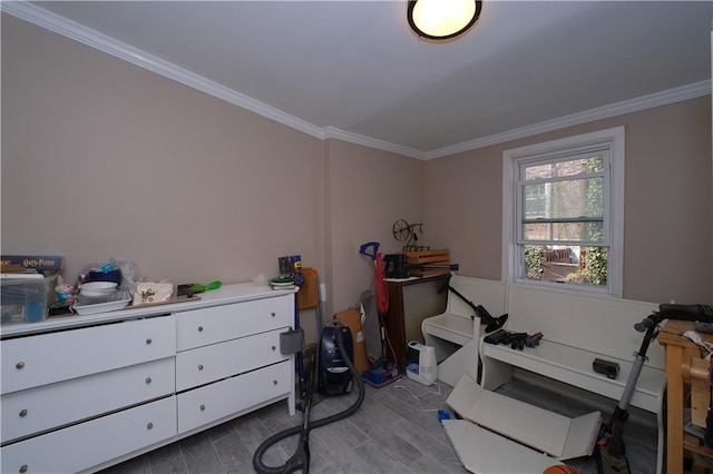 bedroom with crown molding and wood finished floors