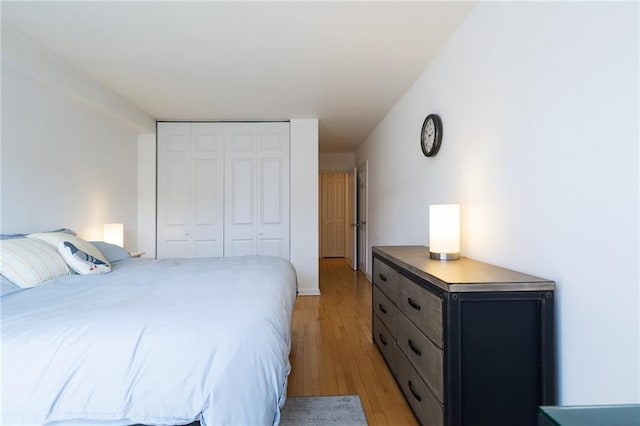 bedroom with a closet and light wood-style flooring