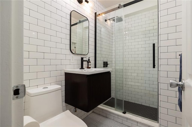 bathroom featuring tile walls, a shower stall, and toilet