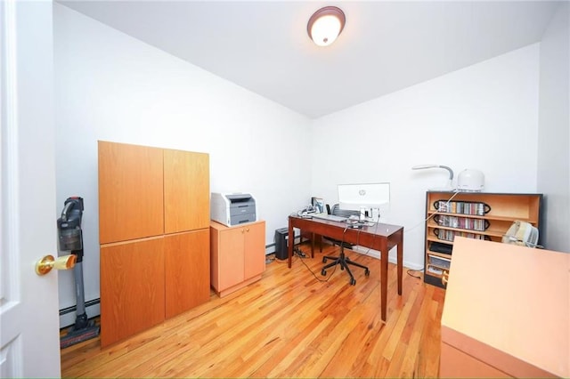 home office featuring baseboard heating and light wood-type flooring