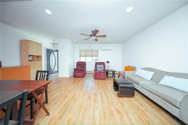 living room with an AC wall unit, recessed lighting, and light wood-style flooring
