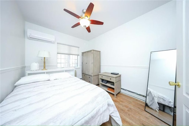 bedroom featuring an AC wall unit, a baseboard radiator, light wood-style floors, and ceiling fan