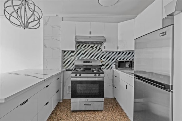 kitchen featuring appliances with stainless steel finishes, white cabinets, backsplash, and extractor fan