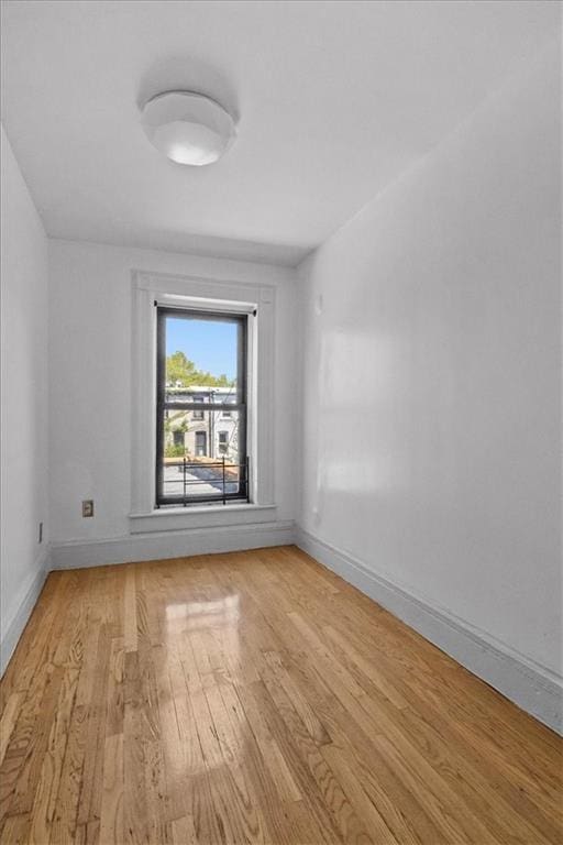 unfurnished room with light wood-style floors and baseboards
