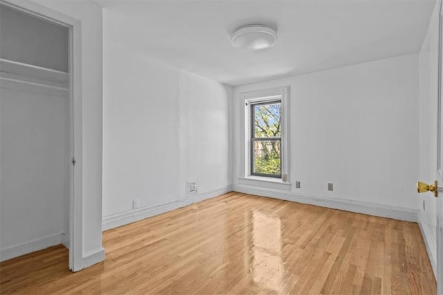 unfurnished bedroom with baseboards and light wood finished floors