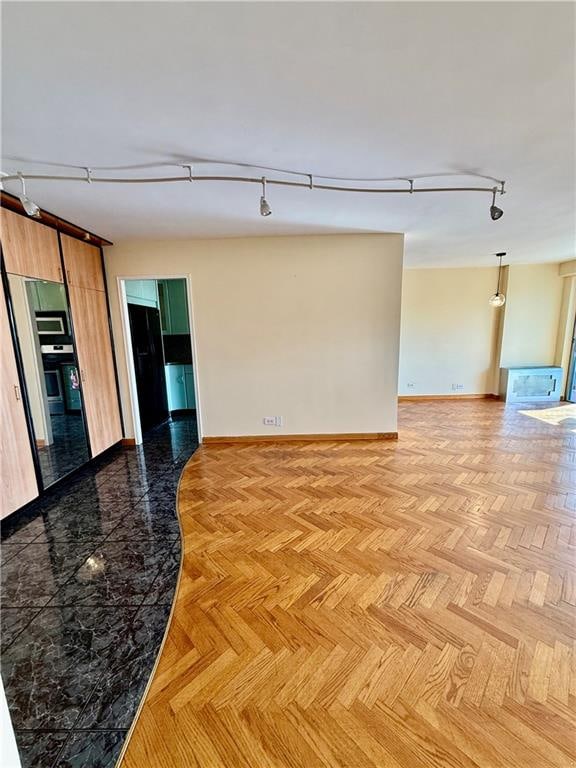 601 Surf Ave Unit 10H, Brooklyn, NY 11224 - empty room featuring track lighting and baseboards