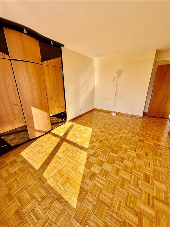 unfurnished room with baseboards