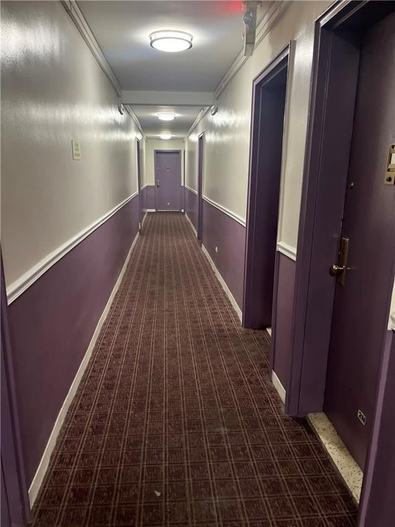 hall featuring baseboards