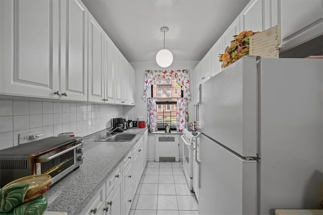 kitchen featuring a toaster, white appliances, radiator heating unit, white cabinets, and a sink