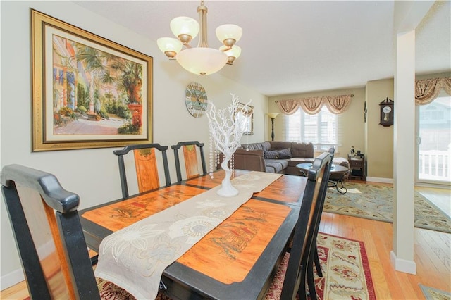 dining space featuring a chandelier and wood finished floors