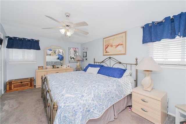 bedroom featuring a ceiling fan and light colored carpet