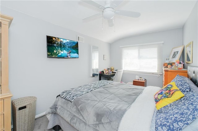 bedroom with a ceiling fan, visible vents, vaulted ceiling, baseboards, and carpet floors