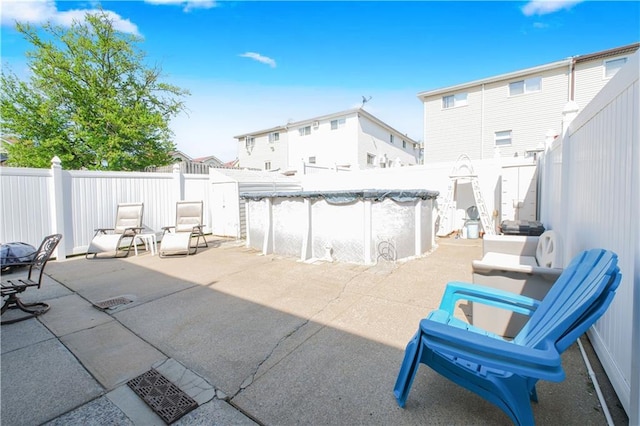 view of patio with a fenced backyard, a fenced in pool, and a residential view