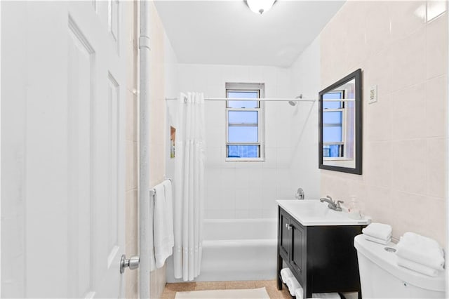 bathroom featuring vanity, tile walls, toilet, and shower / bath combination with curtain