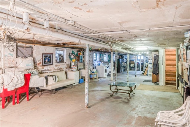 below grade area featuring washing machine and dryer and stairs