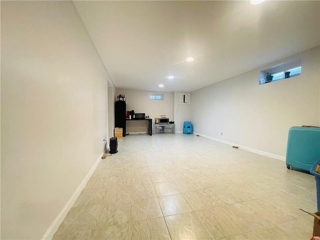 basement featuring baseboards and recessed lighting
