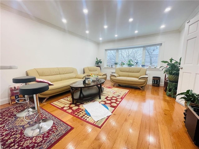 living room featuring ornamental molding and hardwood / wood-style flooring