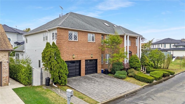 view of property exterior featuring a garage, decorative driveway, and brick siding
