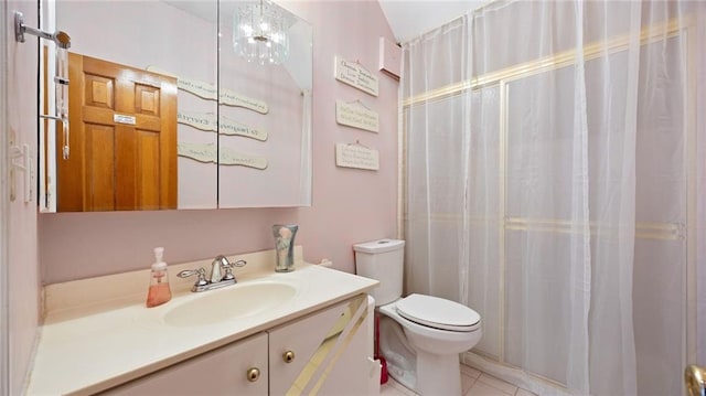 bathroom featuring vanity, tile patterned floors, toilet, and curtained shower