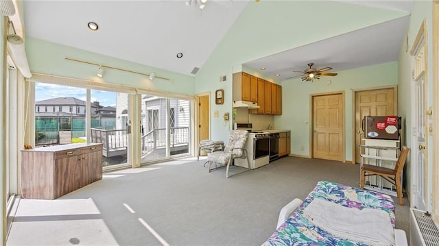 living room featuring a ceiling fan, high vaulted ceiling, and light carpet