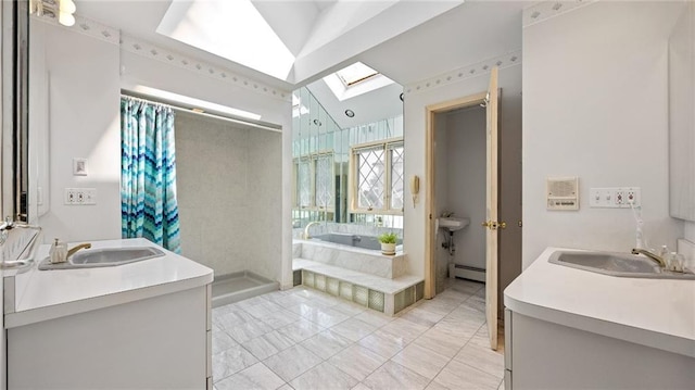 full bath featuring a sink, a baseboard radiator, a skylight, and a shower stall