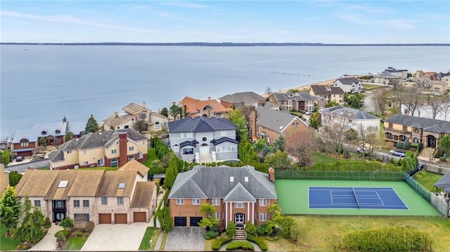 birds eye view of property with a residential view and a water view