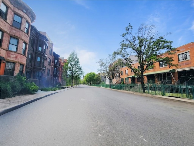 view of street with curbs, sidewalks, and a residential view