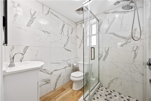 1933 E 28th St, Brooklyn, NY 11229 - full bathroom with toilet, a marble finish shower, wood finished floors, tile walls, and vanity