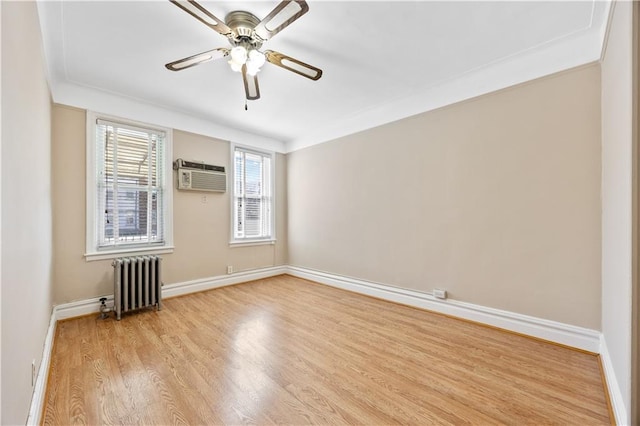 1933 E 28th St, Brooklyn, NY 11229 - spare room featuring radiator, wood finished floors, baseboards, a ceiling fan, and a wall unit AC