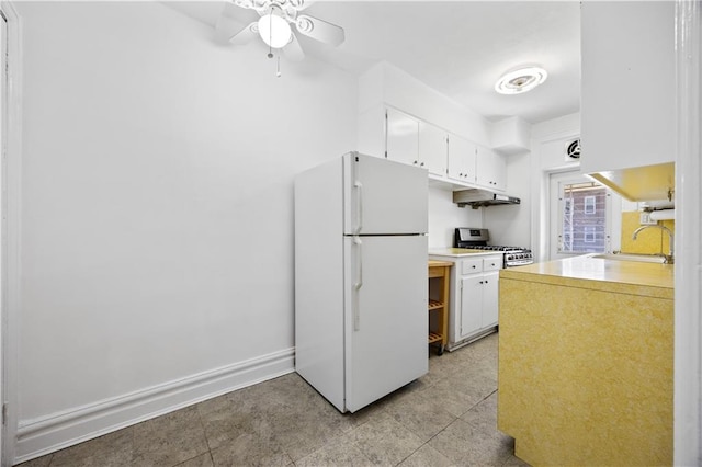 1933 E 28th St, Brooklyn, NY 11229 - kitchen featuring freestanding refrigerator, a sink, white cabinetry, a ceiling fan, and light countertops