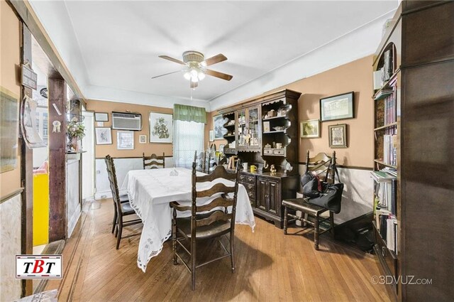 2052 E 28th St, Brooklyn, NY 11229 - dining space featuring ceiling fan, wood finished floors, and an AC wall unit