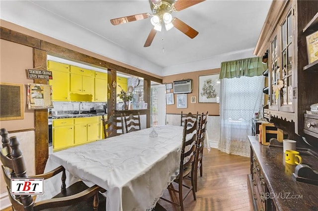 2052 E 28th St, Brooklyn, NY 11229 - dining space featuring wood-type flooring, a wall mounted air conditioner, and ceiling fan
