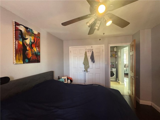 bedroom with washer / dryer, baseboards, and a ceiling fan