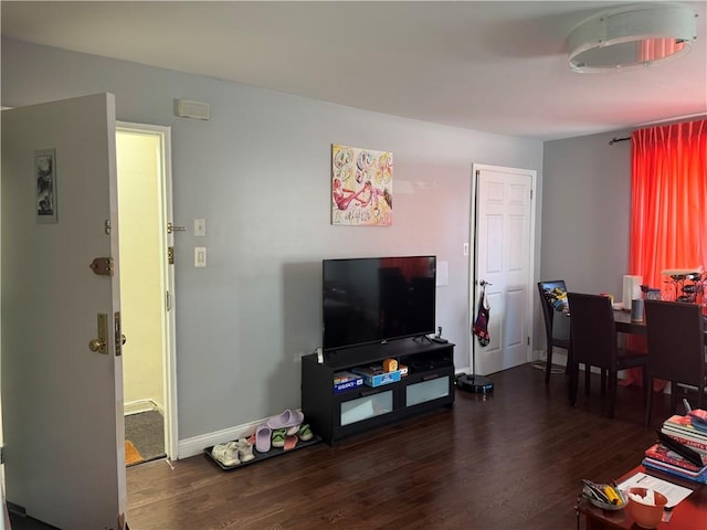 living room with dark wood-style floors and baseboards