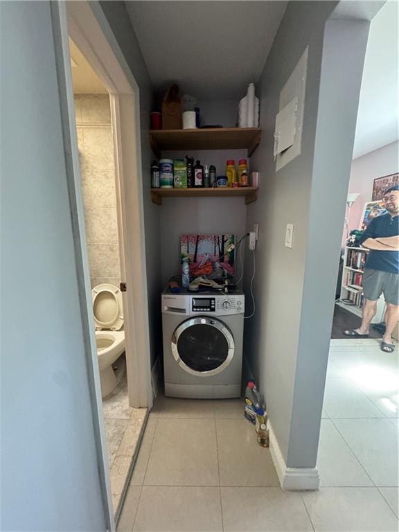 washroom featuring washer / clothes dryer and light tile patterned floors