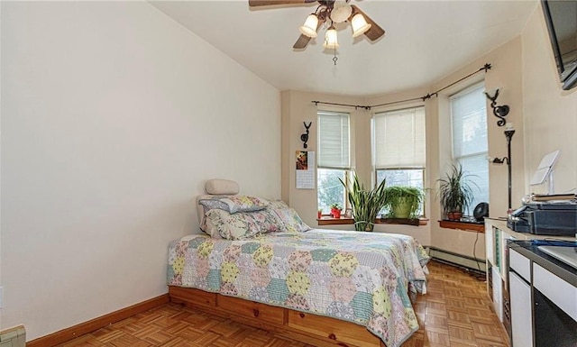 650 51st St Unit 1, Brooklyn, NY 11220 - bedroom featuring baseboards, multiple windows, baseboard heating, and ceiling fan