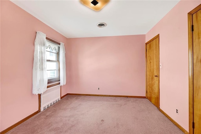 328 Stanley Ave, Staten Island, NY 10301 - empty room with radiator heating unit, light carpet, and baseboards