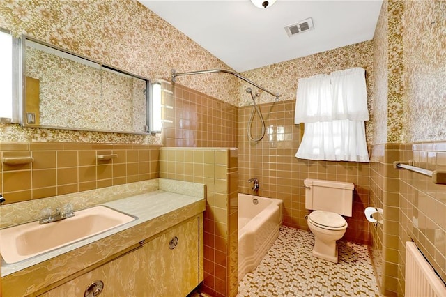 full bath with tile walls, radiator heating unit, visible vents, and wallpapered walls