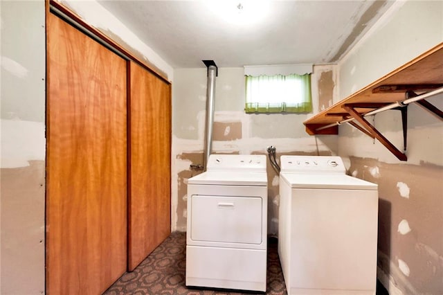 clothes washing area featuring laundry area and washing machine and clothes dryer