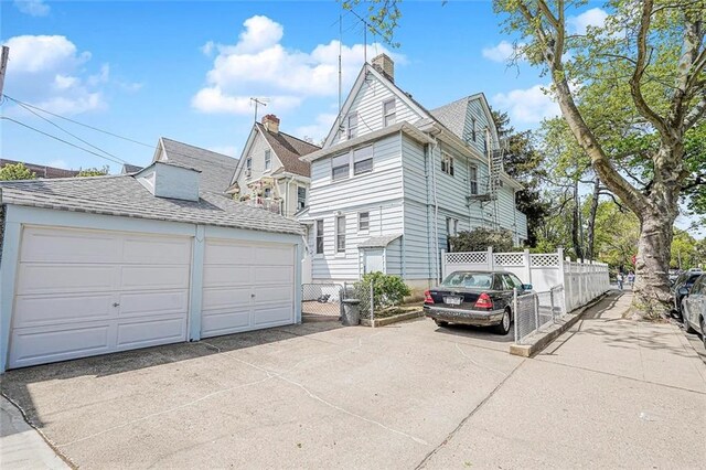 222 Albemarle Rd, Brooklyn, NY 11218 - view of side of property featuring an outdoor structure, fence, a garage, and a chimney