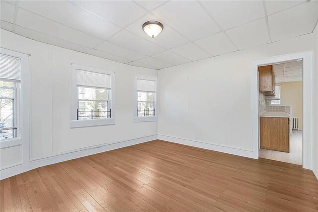 222 Albemarle Rd, Brooklyn, NY 11218 - empty room featuring hardwood / wood-style floors, a paneled ceiling, radiator, and baseboards