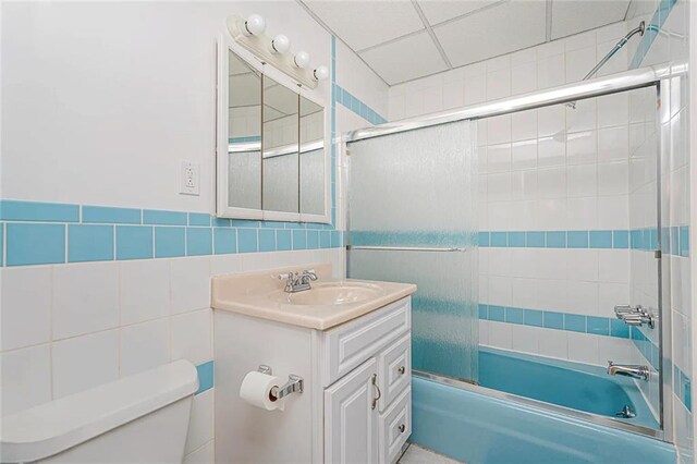 222 Albemarle Rd, Brooklyn, NY 11218 - full bathroom featuring toilet, enclosed tub / shower combo, vanity, and tile walls