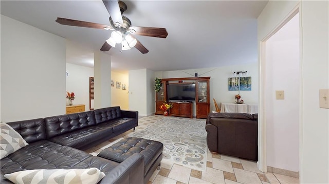 living room featuring baseboards and a ceiling fan