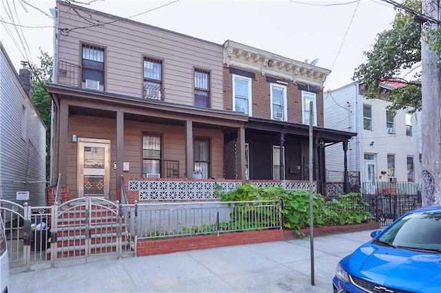 94 Wyona St, Brooklyn, NY 11207 - view of front of house featuring covered porch and a gate