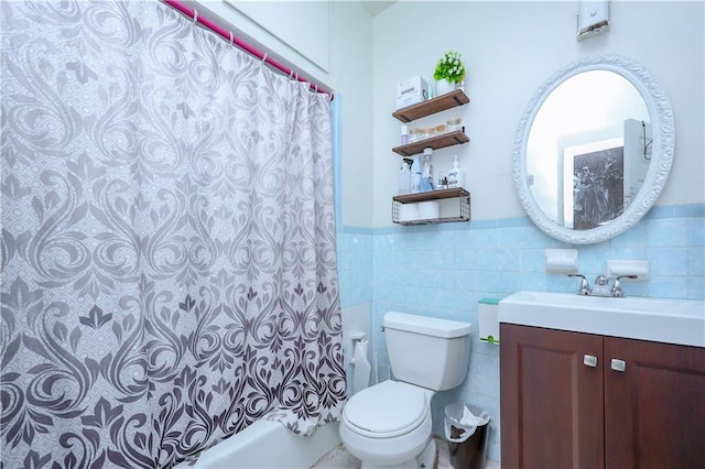 94 Wyona St, Brooklyn, NY 11207 - bathroom featuring vanity, tile walls, shower / bath combination with curtain, and a wainscoted wall