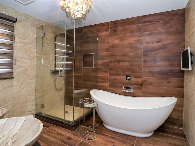 166 Pinewood Ave, Staten Island, NY 10306 - full bathroom with a freestanding tub, a stall shower, a chandelier, and wood finished floors