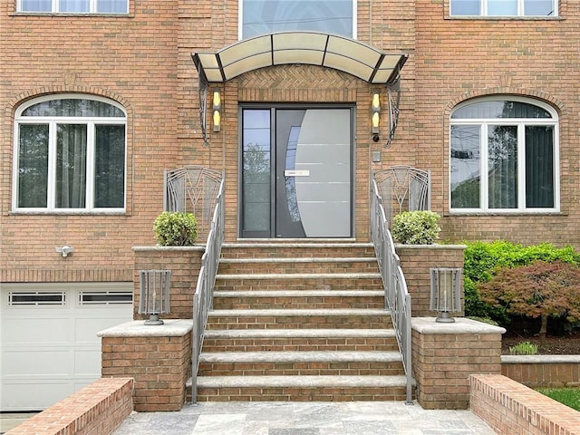 166 Pinewood Ave, Staten Island, NY 10306 - property entrance with brick siding and an attached garage