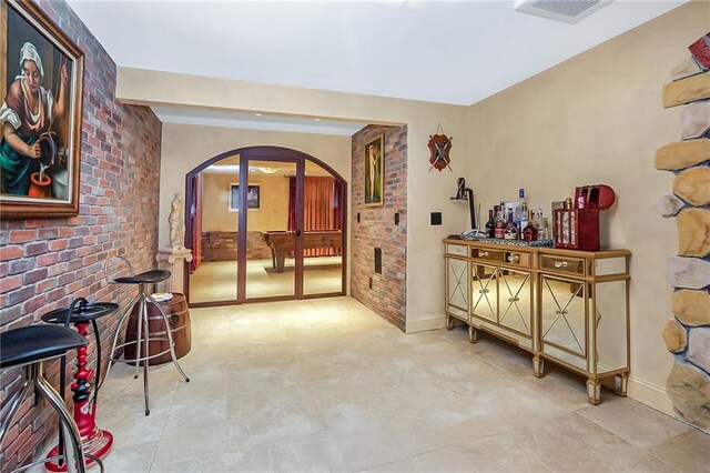 166 Pinewood Ave, Staten Island, NY 10306 - hallway with arched walkways, baseboards, and brick wall