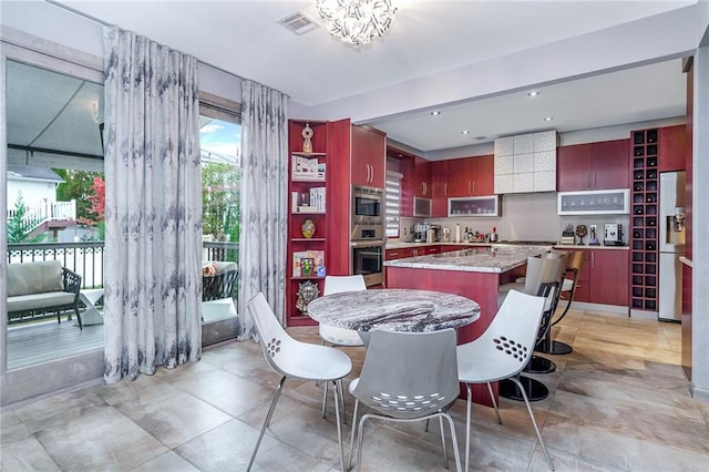 166 Pinewood Ave, Staten Island, NY 10306 - dining room with plenty of natural light, a chandelier, and light tile patterned floors